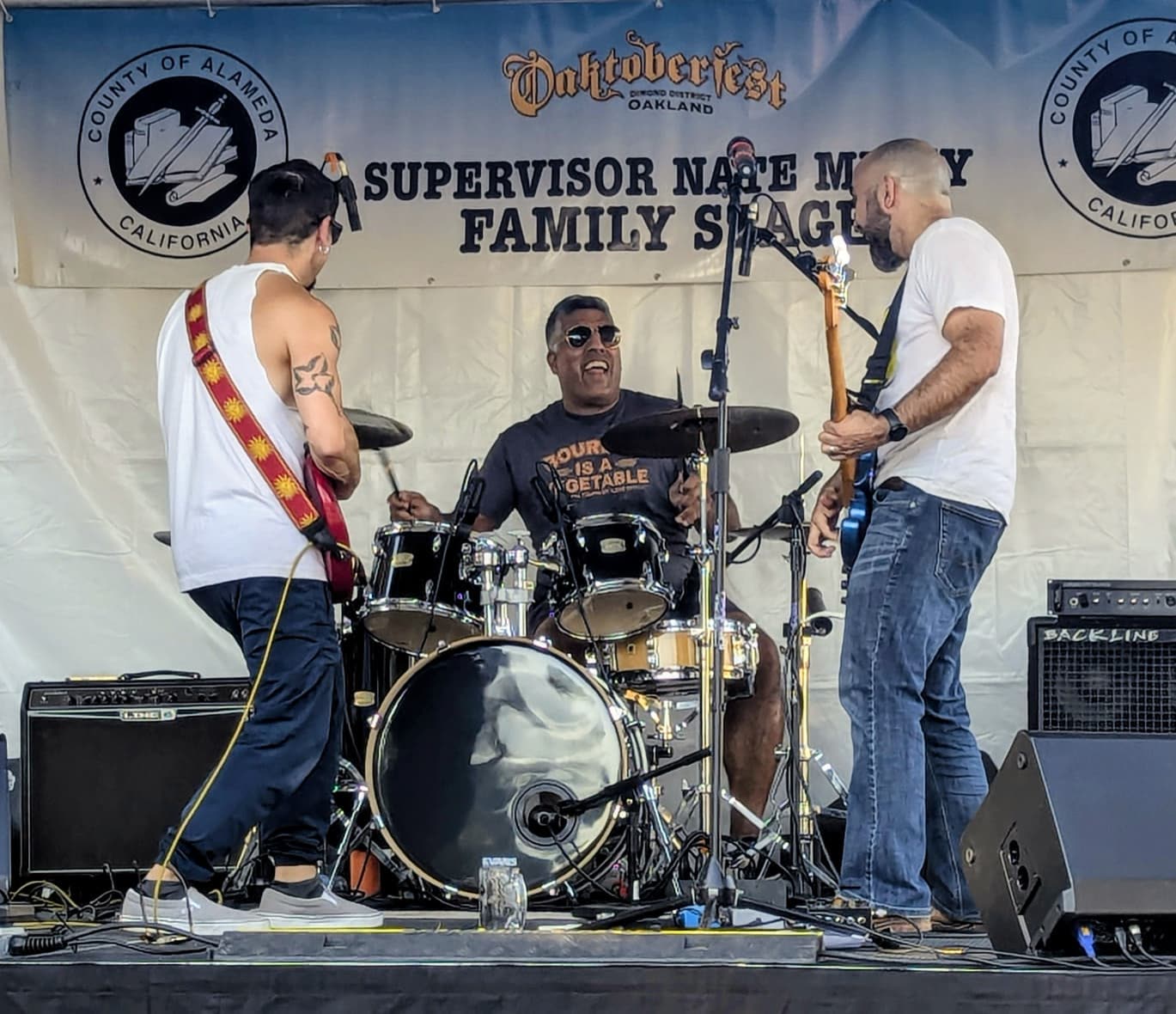 The three of us mid-song on the Supervisor Nate Miley Family Stage.