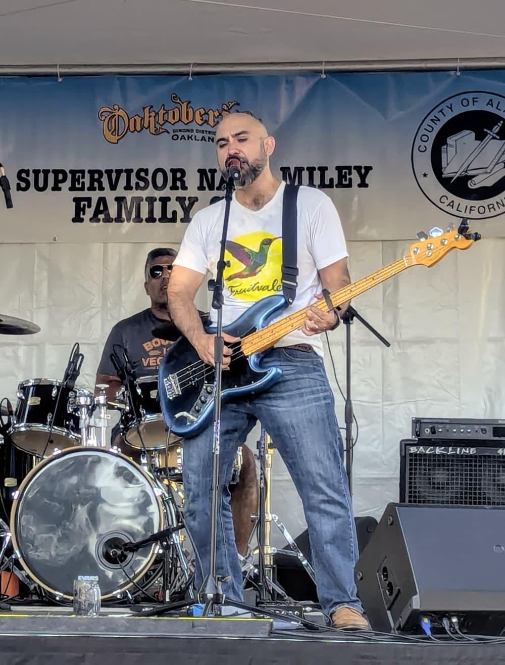 Bass player singing into the microphone.