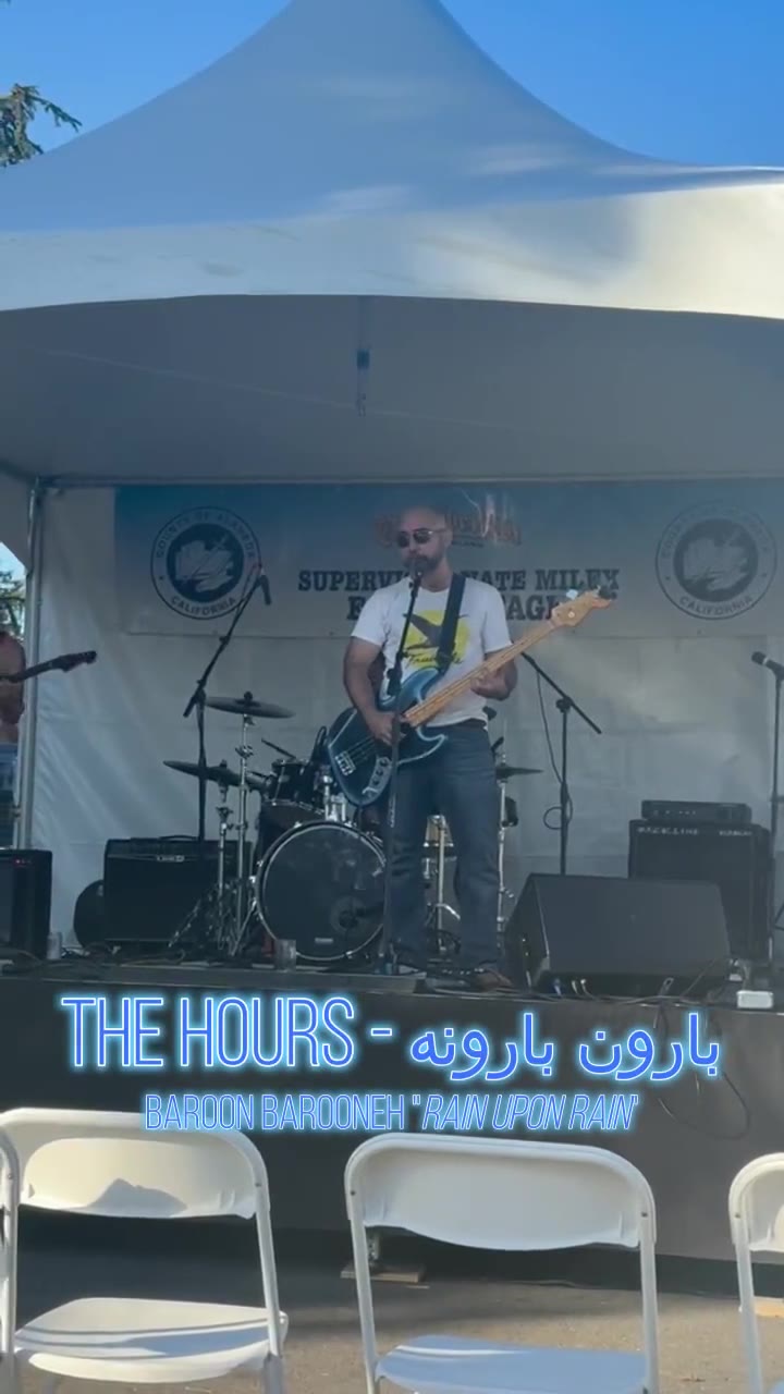 The band on stage, with the title The Hours, Baroon Barooneh, Rain Upon Rain across the bottom.